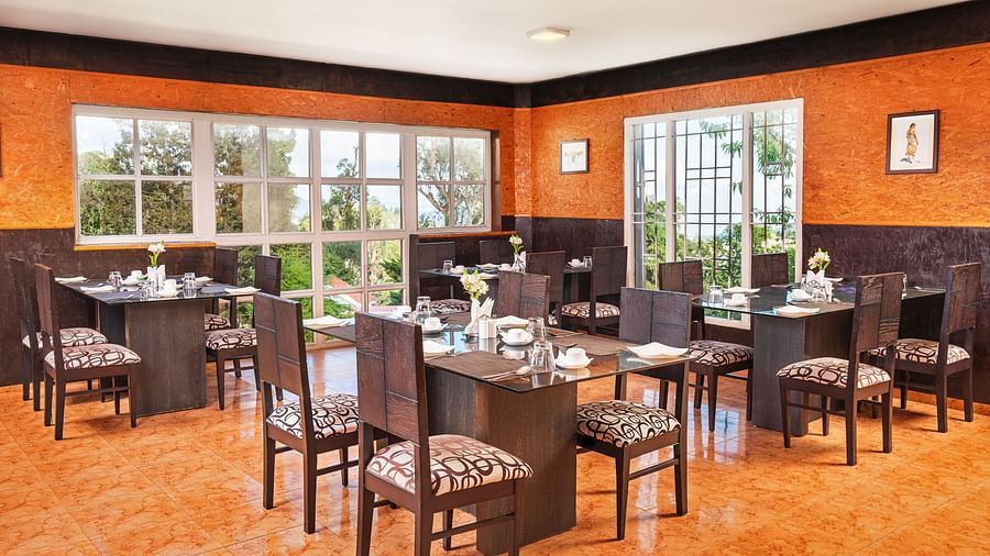 A picture of a banquet hall with fou-seater tables | Mango Hill, Kodaikanal
