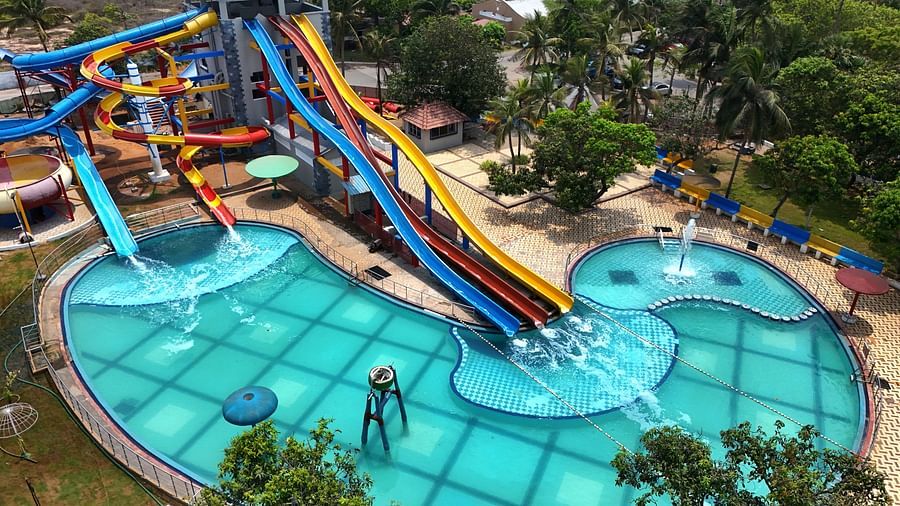 Side view of swimming pool with slides