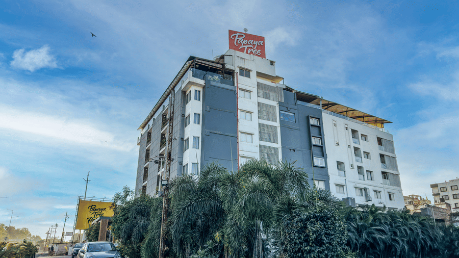 Exterior of Papaya Tree Hotels showcasing the modern multi-storey building and surrounding greenery.