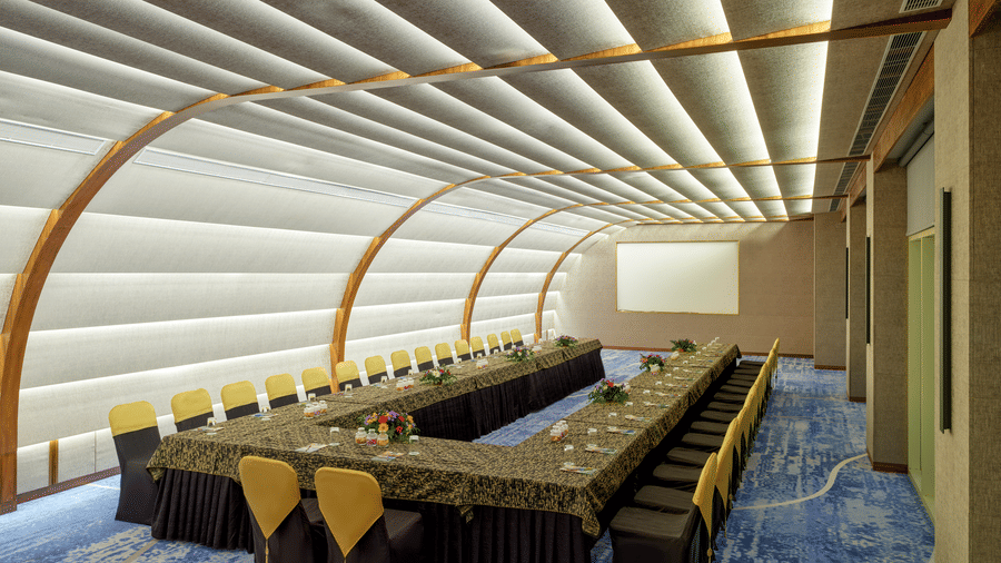 The Panorama hall at Swosti Premium Beach Resorts, Puri, with tables and chairs, featuring the signature curved ceiling and wall design of the event space.