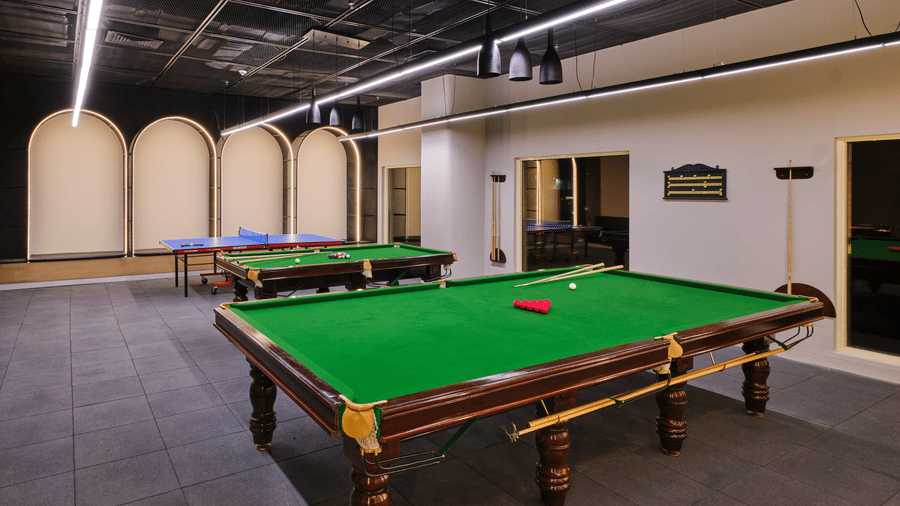 Relay-The Games room at Swosti Premium Beach Resorts, Puri, featuring a green felt pool table as the central focus.