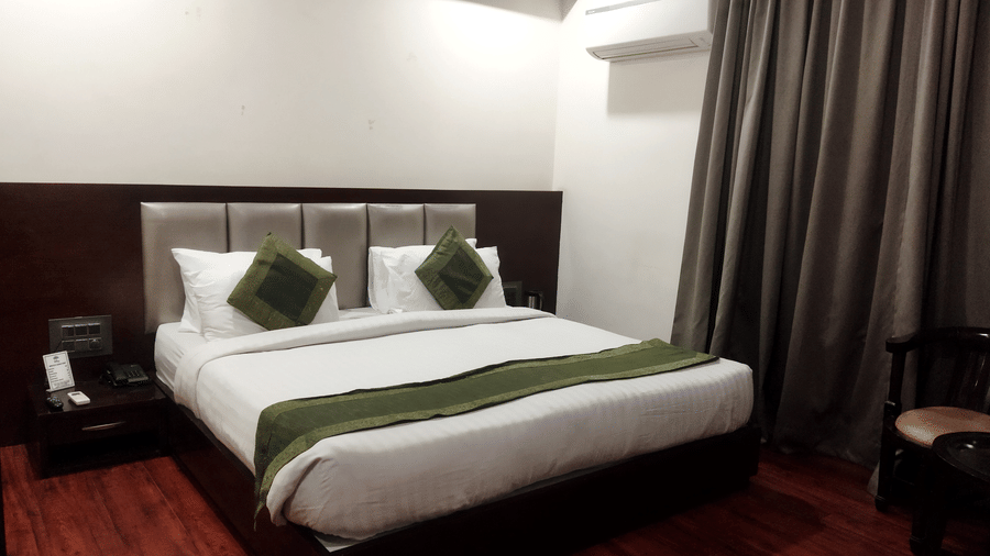 Modern accommodation with a comfortable double bed and calming interiors at TGI Apple Inn, Ajmer Road, Jaipur.