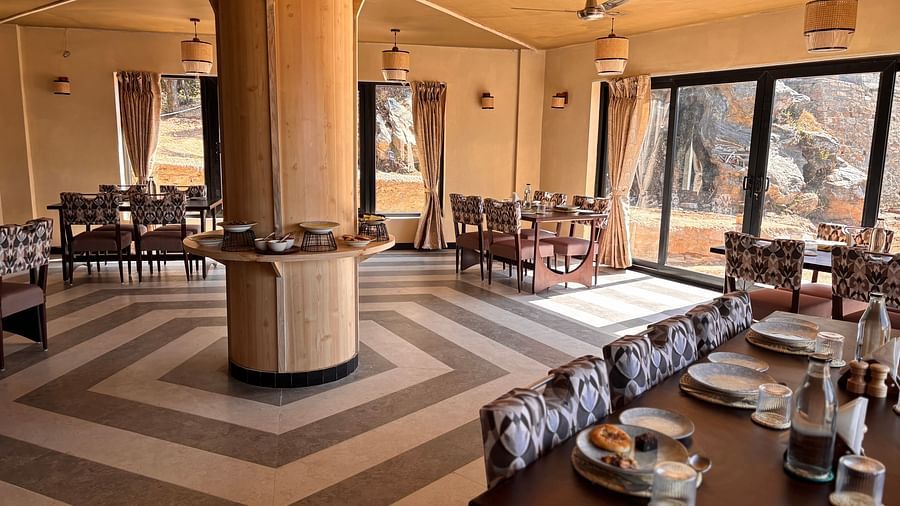 A dining area at The Chamomile Estate with tables and chairs set atop a patterned floor.