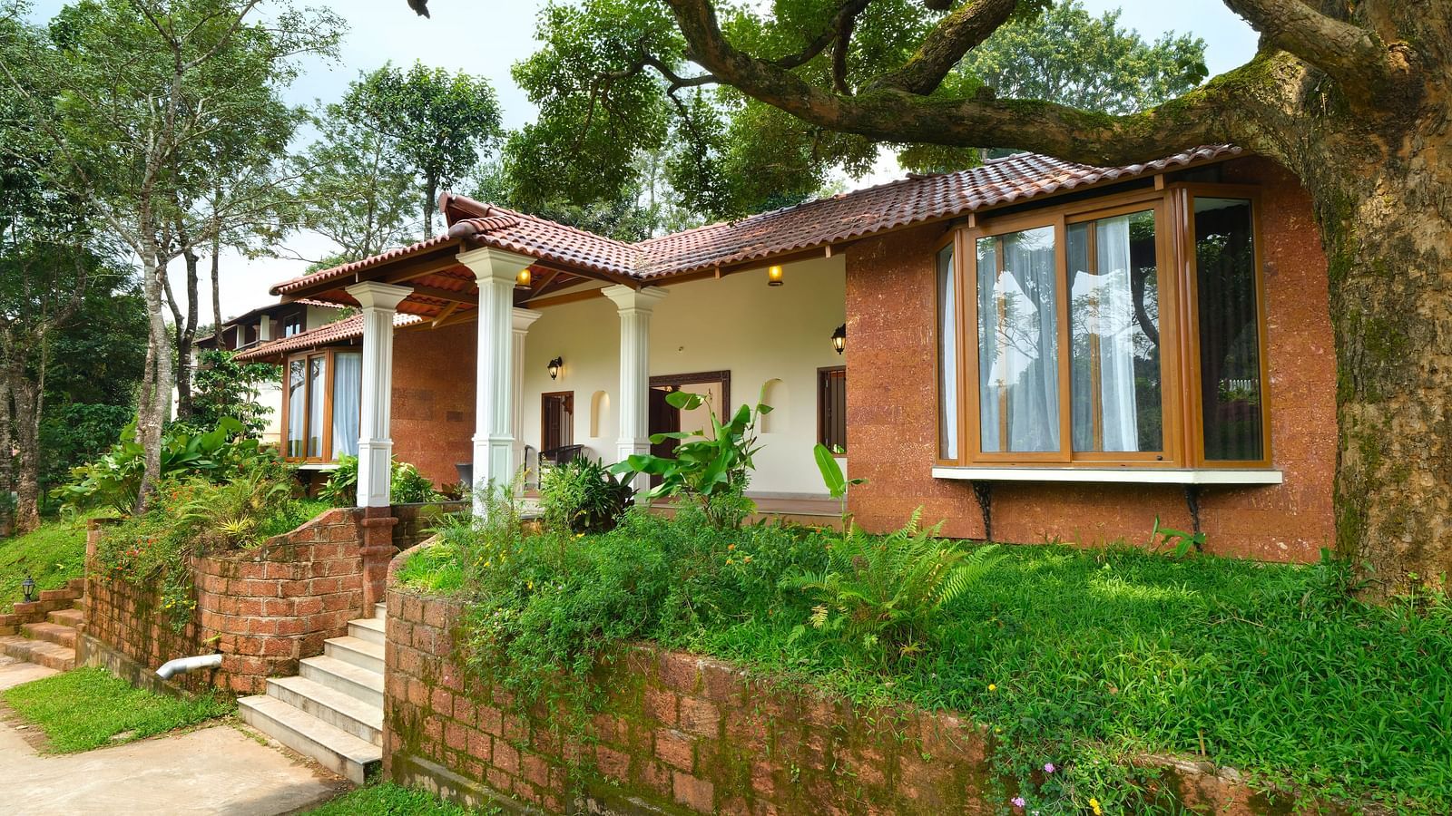 A cottage at our resort surrounded by green trees