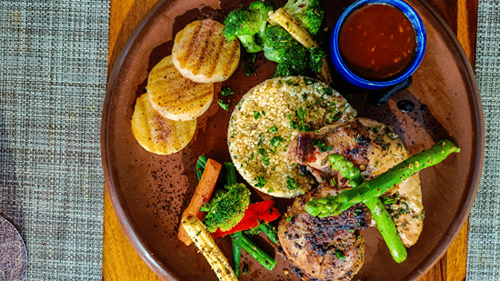 Quinoa, sauce, grilled vegetables, and chicken as seen from above - Karma Lakelands.