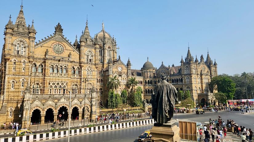 full image of the chatrapati shivaji maharaj terminus in mumbai on a bright afternoon with an empty road in front of it