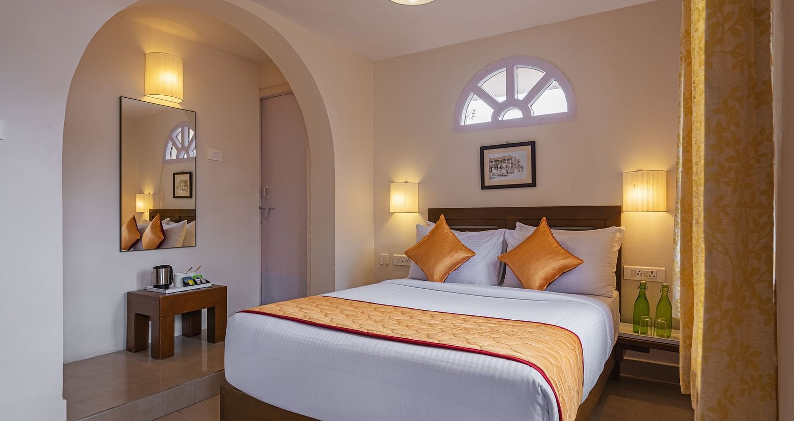 A bedroom with double-sized bed, lamps on each side ansd other amenities included | Mango Hill, Kodaikanal
