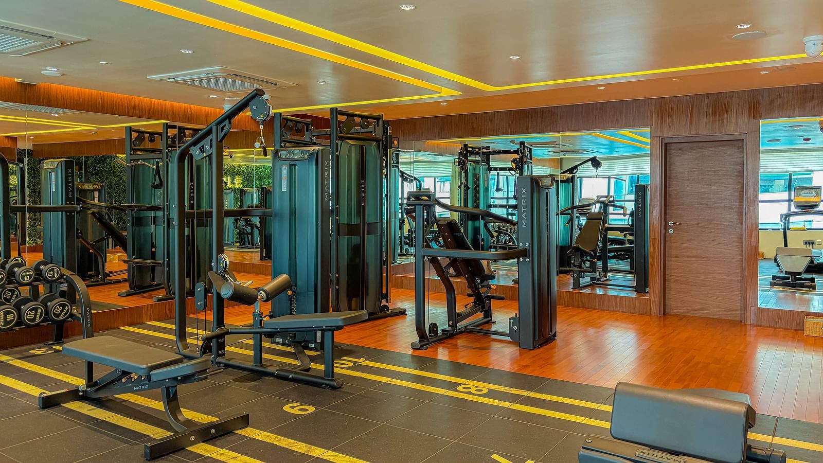 Fitness Center at KertelSuites, featuring modern gym equipment and stylish flooring designed