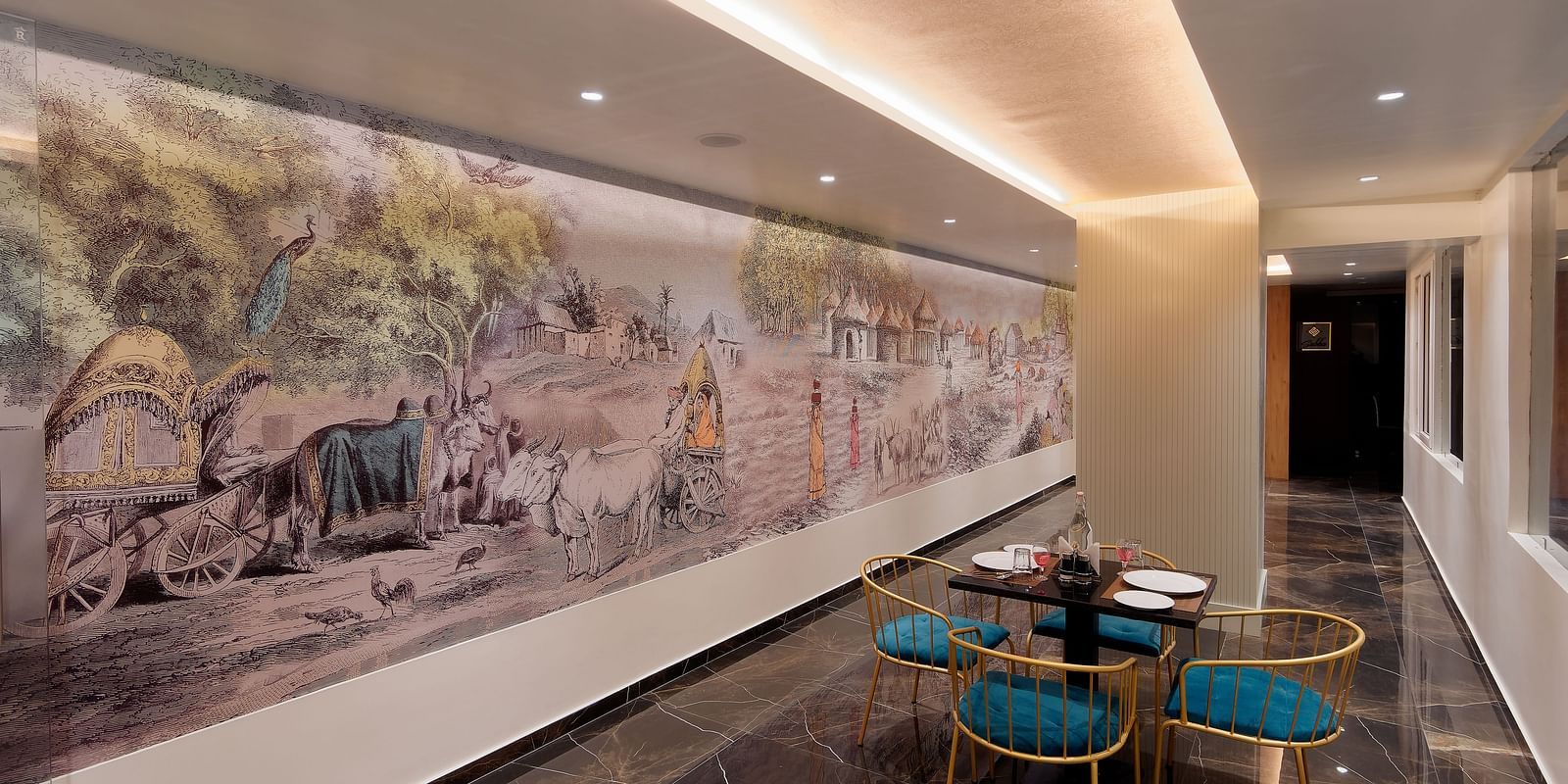 Image of seating area with chairs and tables and mural on the wall at Ankit Hotel, Jabalpur