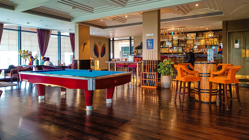 Seating arrangements with a pool table inside AKs Cocktail Bar - Karma Lakelands.