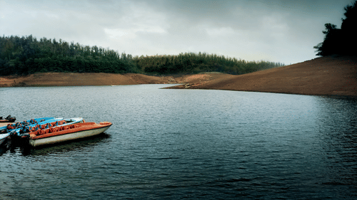 Lake surrounded by greenery and hills