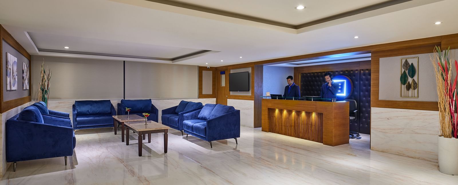 Well-lit lobby area of Essentia Premier Hotel, Chennai with sofa seating and a coffee table