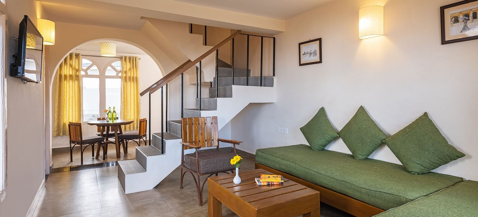 An image of a sitting room and a flight of stairs leading on the corner leading to first floor | Mango Hill, Kodaikanal