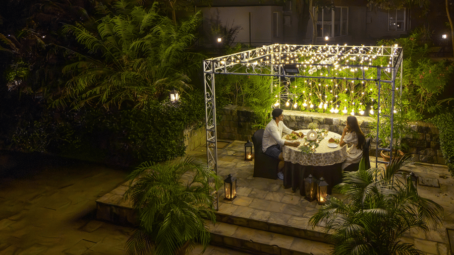 A night view of an outdoor dining area at The Golden Tusk, Jim Corbett