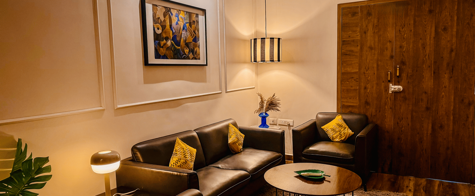 Separate living room of Coral 4BHK at Kove Smart Stays seen under ambient lighting.