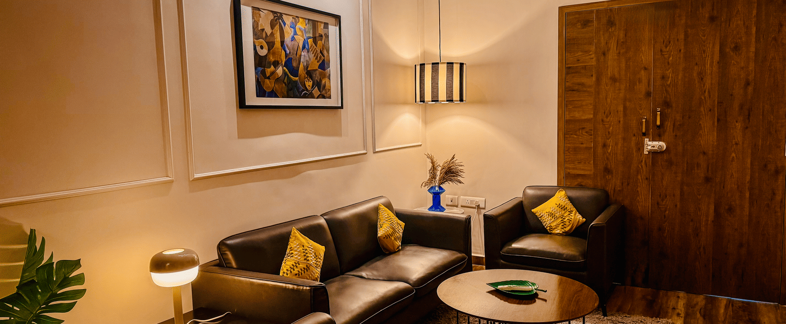 Separate living room of Coral 4BHK at Kove Smart Stays seen under ambient lighting.