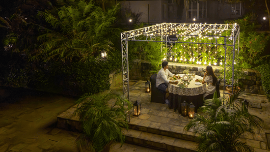 A night view of an outdoor dining area at The Golden Tusk, Jim Corbett