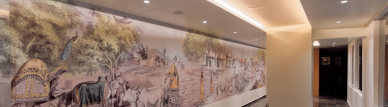 Image of seating area with chairs and tables and mural on the wall at Ankit Hotel, Jabalpur
