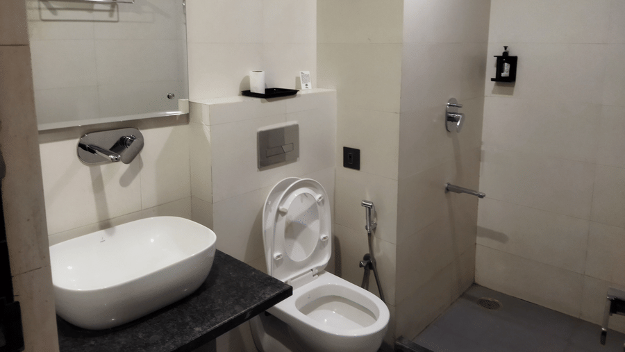Clean and contemporary bathroom with shower area and modern fittings at TGI Apple Inn, Ajmer Road, Jaipur.