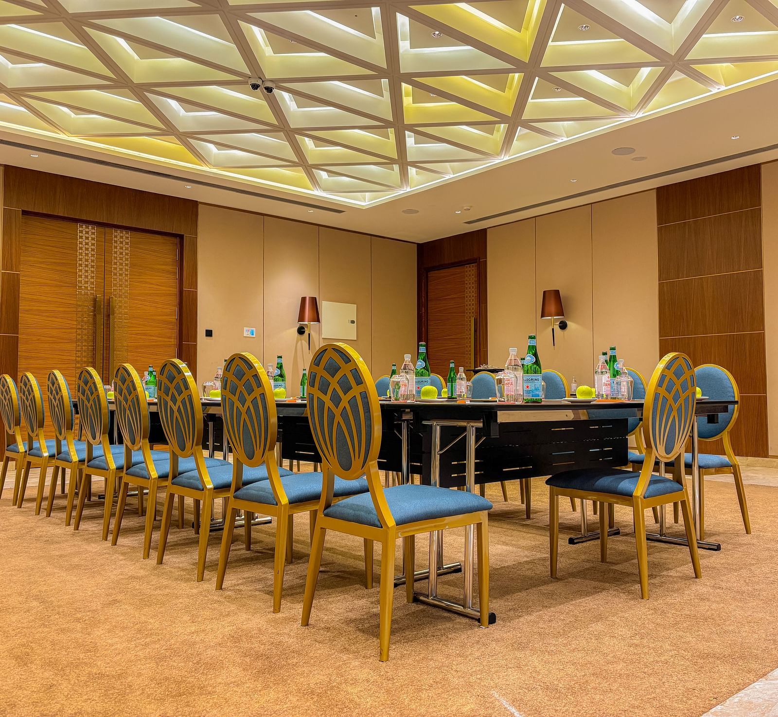 Banquet Hall at KertelSuites, featuring a long table with elegant chairs, complemented by a stylish ceiling and ambient lighting