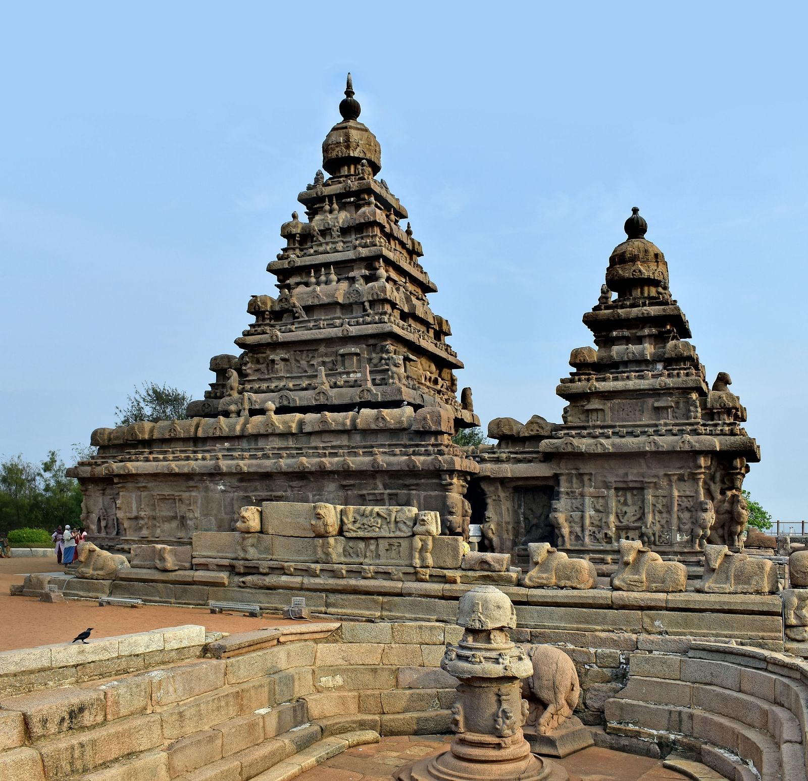 A far out view of ancient temples in mahabalipuram with blue sky in the background