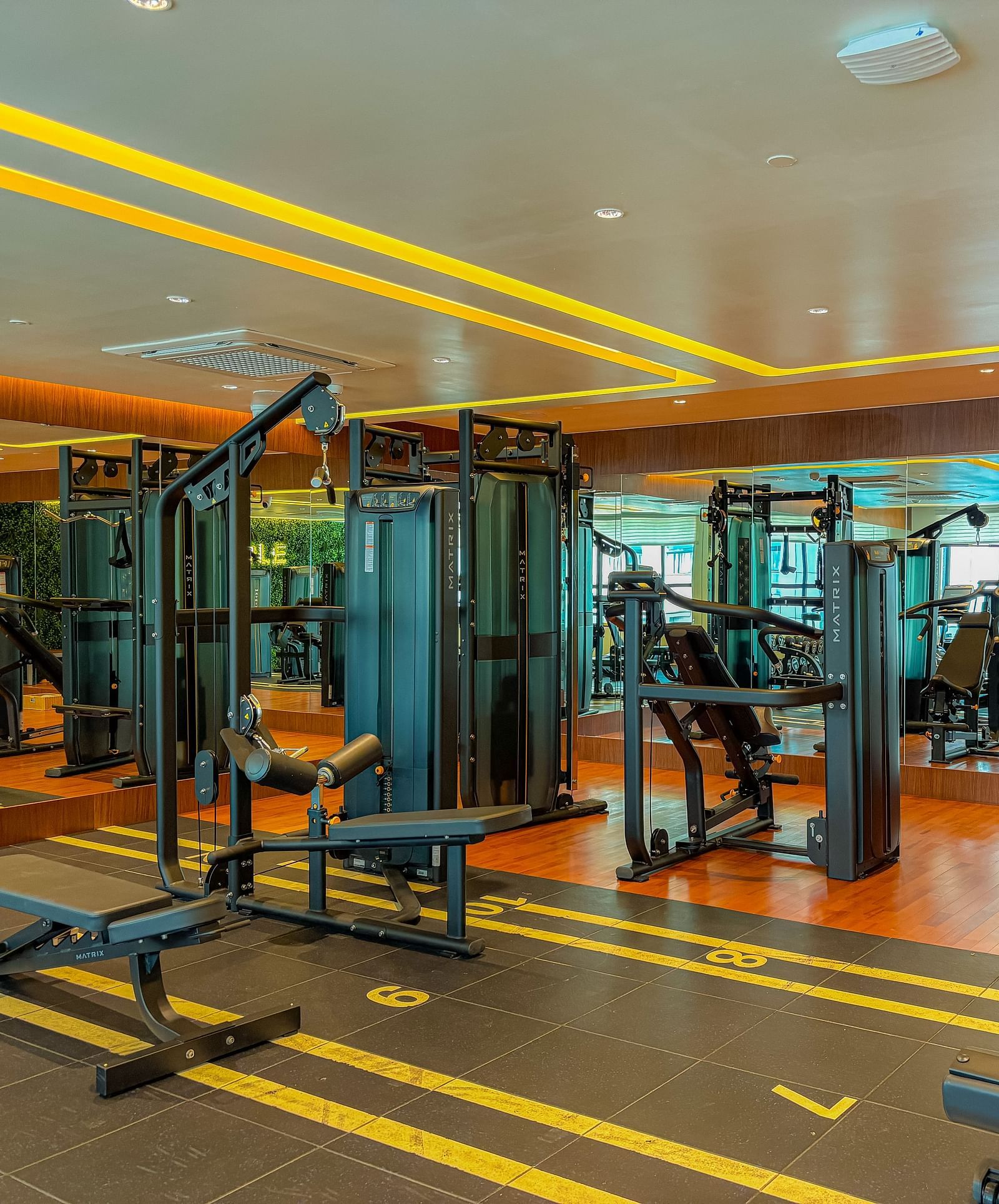 Fitness Center at KertelSuites, featuring modern gym equipment and stylish flooring designed