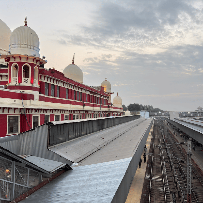 A ariel view of the Charbagh Station, Lucknow. The red walls with its white peaks are visible along with the train tracks..