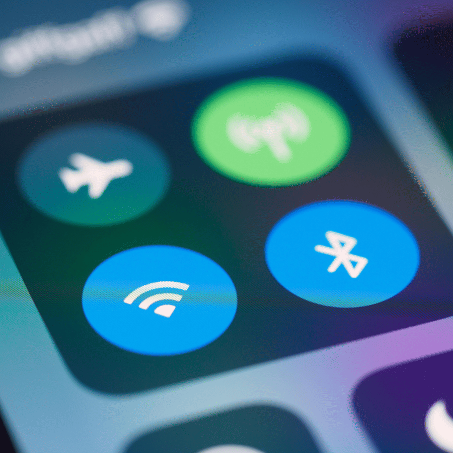 Close-up of smartphone screen showing WiFi, Bluetooth, airplane mode, and hotspot icons in control center.