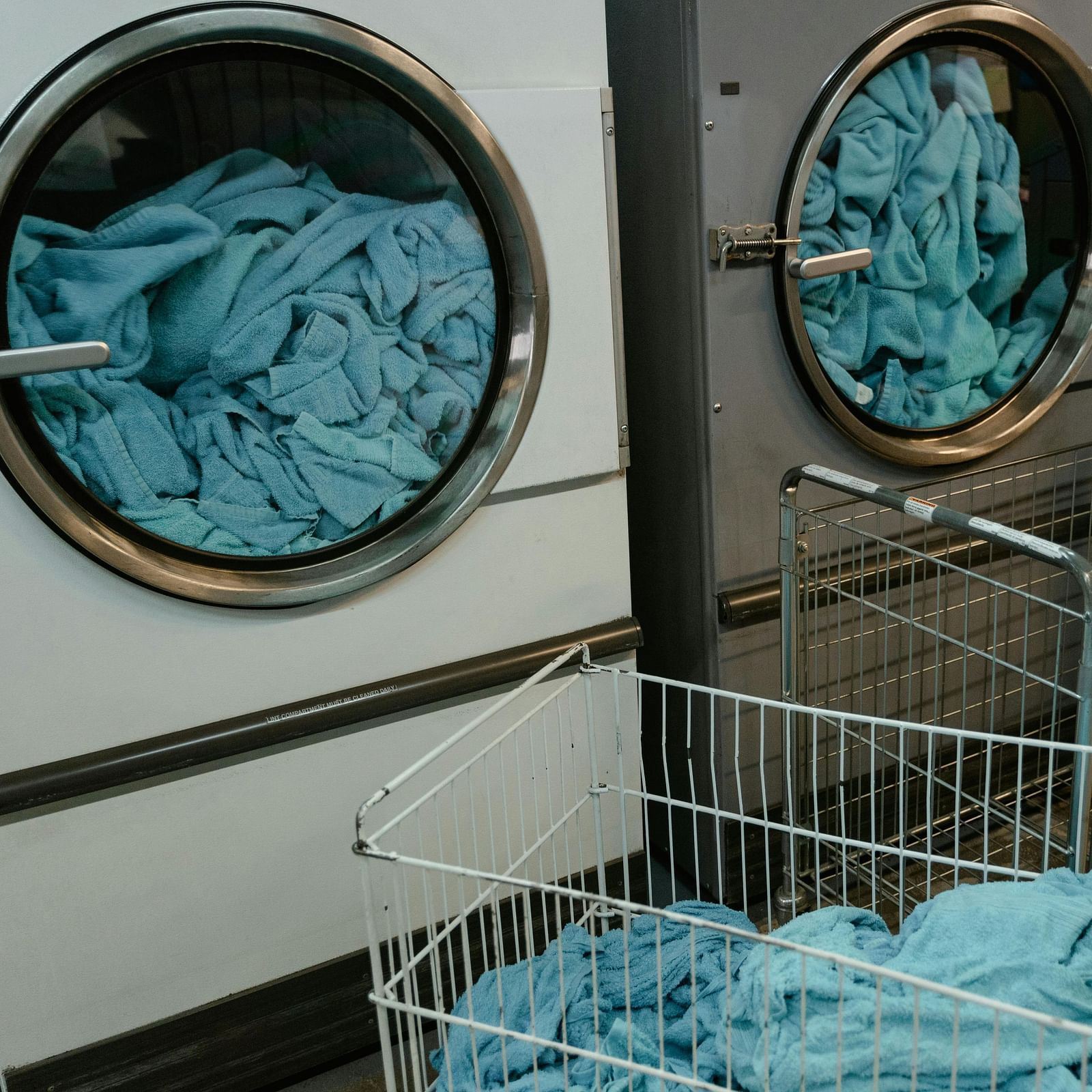 White and Gray Washing Machine with Blue Fabrics inside