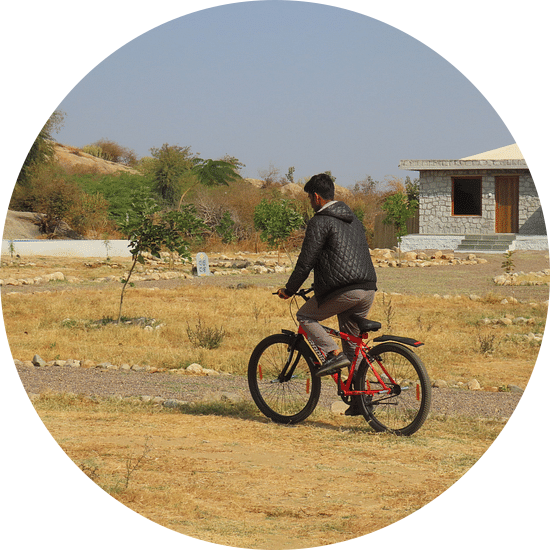 A person cycling on a field at Clark s Safari Jawai