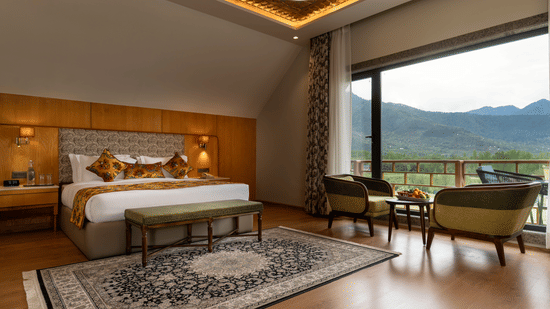 Luxury bedroom at Mountnoor Sarovar Premiere, Pahalgam with elegant interiors and stunning mountain views.