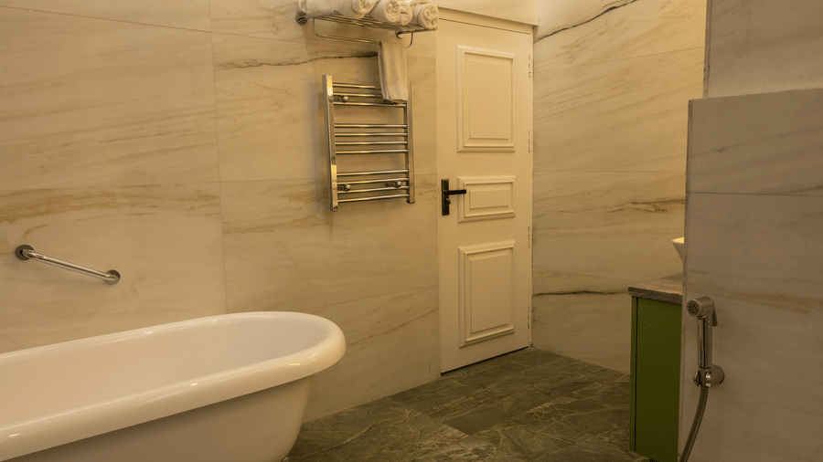 A bathroom at The Heritage Club, Tripura, Castle, Shillong, featuring a bathtub.