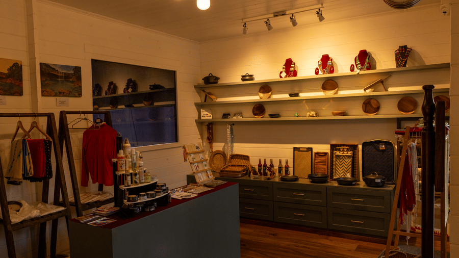 An illuminated Souvenir shop with a window, clothes, and other small items placed on a shelf. | The Heritage Club, Tripura, Castle, Shillong