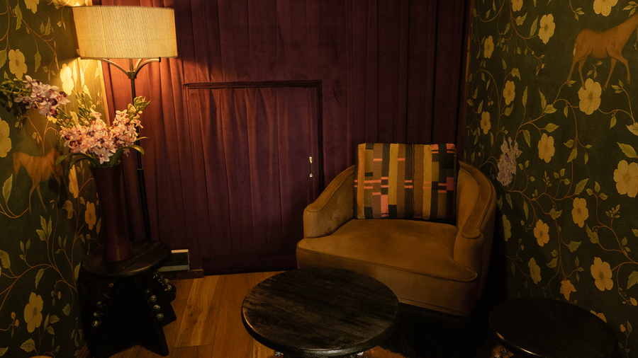 A dining space with sofas, a table, and a lamp. | The Heritage Club, Tripura, Castle, Shillong