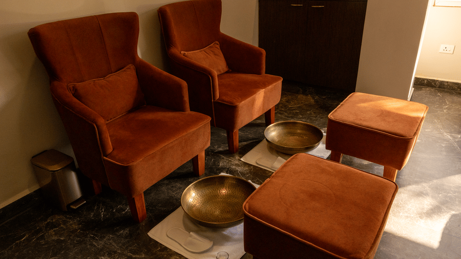 A spa with cushions, tables, and bowls setup for massage. | The Heritage Club, Tripura, Castle, Shillong.