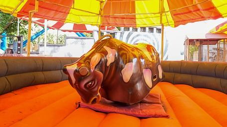 A bull ride at MGM Dizzee World where people sit and the bull rotates on a cushion bed. 