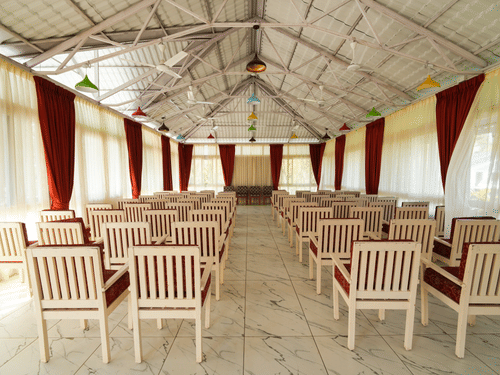 Picture of the banquet hall with the chairs arranged for an event.