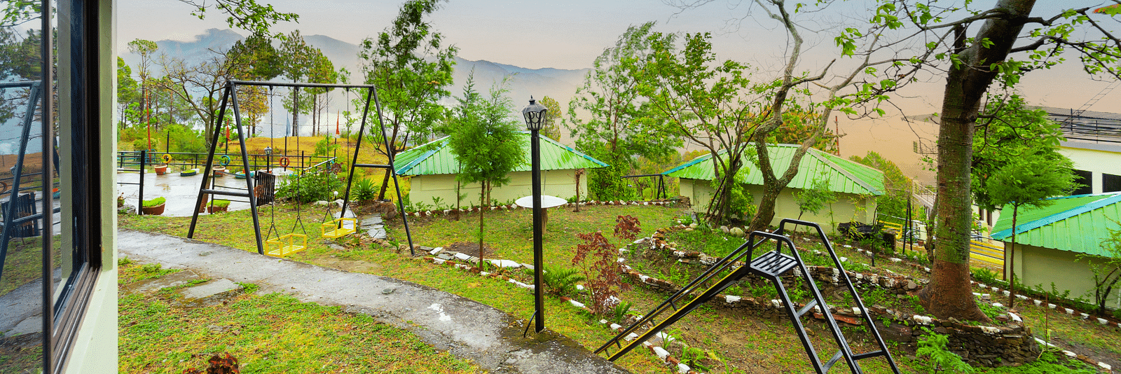 a view of a garden featuring a slide and a swing at Flutter Hotels & Resorts
