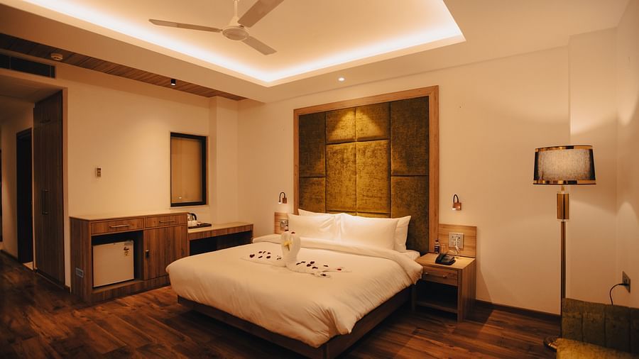 Clarks Inn Express Dehradun - interior view of the executive room featuring a queen size bed and lamp in yellow lighting