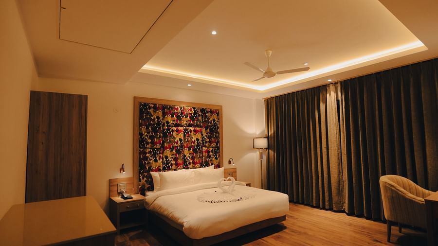 Clarks Inn Express Dehradun - interior view of the executive room featuring a queen size bed and wooden flooring