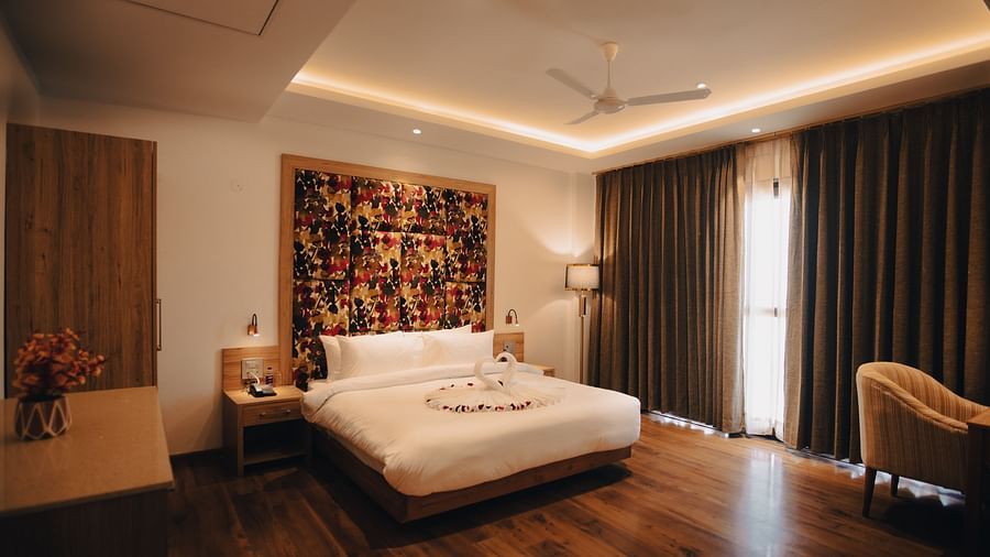 Clarks Inn Express Dehradun - interior view of the suite with king size work table and brown coloured decor