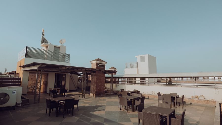 Clarks Inn Express Dehradun - view of the property s terrace with a brick pillar supporting a glass roof that covers a pair of tables and chairs