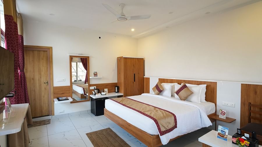 A spacious bedroom with comfortable beds and stylish decor - MGM Whispering Wind's Resorts