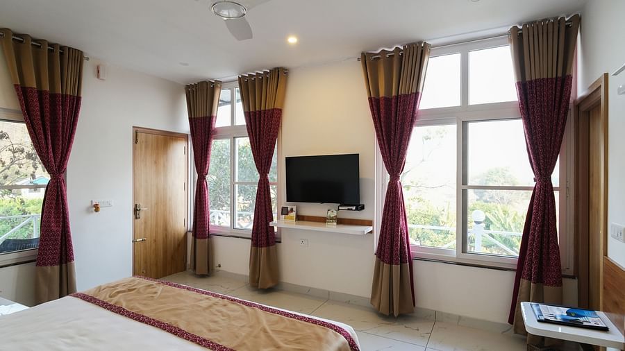 A spacious bedroom with comfortable beds and stylish decor - MGM Whispering Wind's Resorts