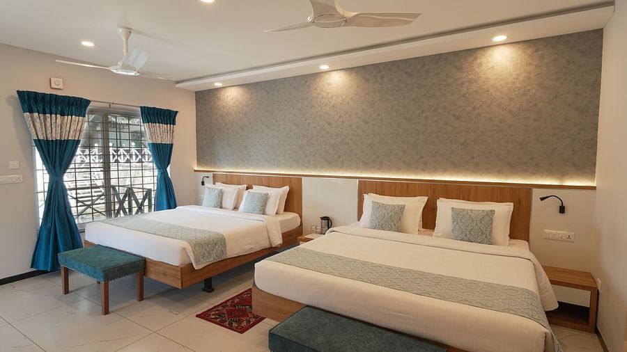 A spacious and well-lit room with comfortable beds and modern decor - MGM Whispering Wind's Resorts