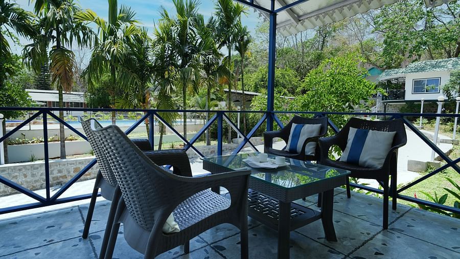 A private balcony overlooking a beautiful garden - MGM Whispering Wind's Resorts
