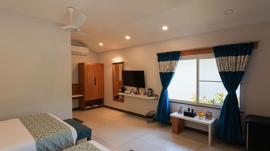 A beautifully decorated bedroom with a comfortable bed and a view of the outdoors - MGM Whispering Wind's Resorts