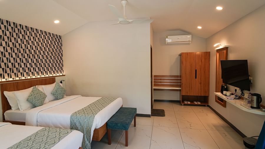 A spacious and bright bedroom with comfortable beds and stylish decor - MGM Whispering Wind's Resorts