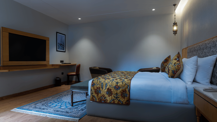 Modern guest room at Mountnoor Sarovar Premiere, Pahalgam offering refined interiors and a relaxing ambience.