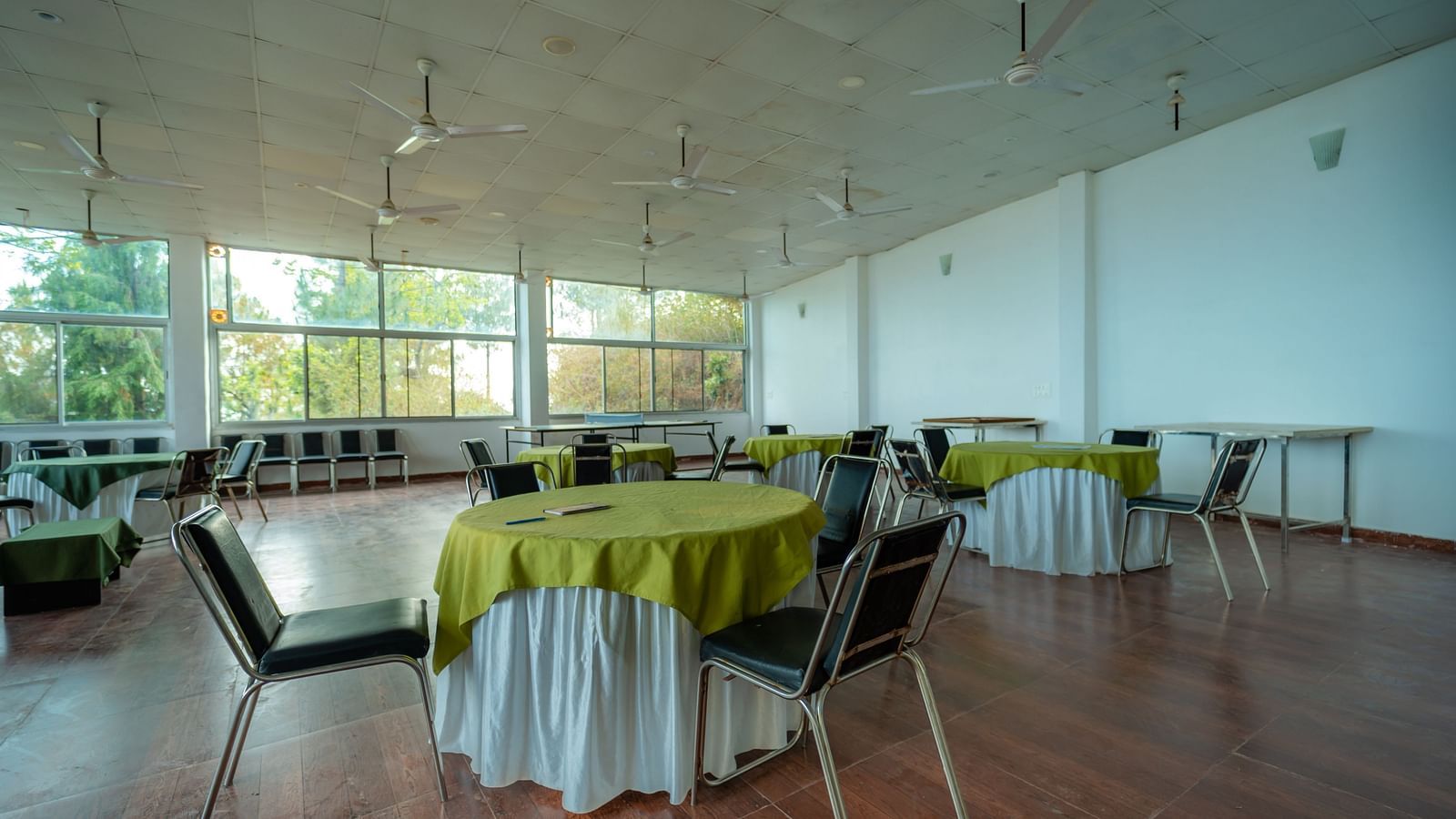 tables and chairs placed in the event venue at Flutter Hotels & Resorts surrounded by beautiful view of the valleys